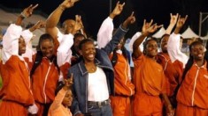Texas women's coach Bev Kearney celebrates with team after the Longhorns won the team title in the NCAA Track & Field Championships
