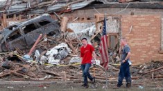 Two men stand in front of Plaza Towers Elementary after a tornado destroyed the school on Monday.