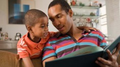 african american man and boy reading