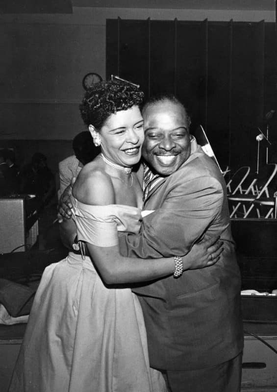 EBONY Collection- Billie Holliday and Count Basie embrace at performance.