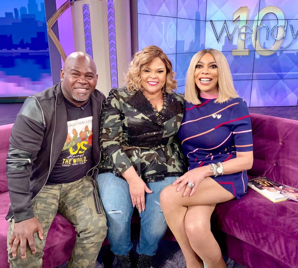 Power couple David and Tamela Mann posing with Wendy Williams