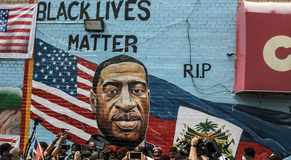 NEW YORK, NY - JULY 13: A mural painted by artist Kenny Altidor depicting George Floyd is unveiled on a sidewall of CTown Supermarket on July 13, 2020 in the Brooklyn borough New York City. George Floyd was killed by a white police officer in Minneapolis and his death has sparked a national reckoning about race and policing in the United States. (Photo by Stephanie Keith/Getty Images)