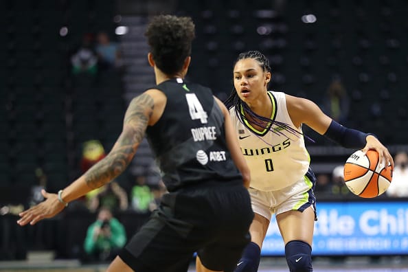 Satou Sabally, #0 of the Dallas Wings, dribbles the ball as Candice Dupree #4 of the Seattle Storm defends the play during the fourth quarter at Angel of the Winds Arena on June 06, 2021 in Everett, Washington. Image: Abbie Parr/Getty Images.