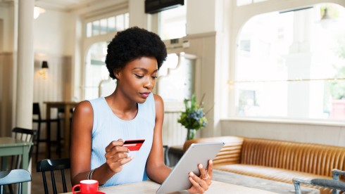 Woman with credit card and tablet