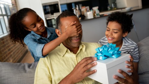 Kids surprising their father with a gift for Father’s Day