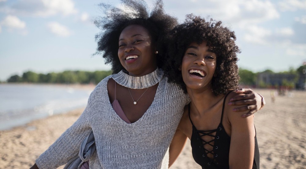 black-women-laughing-beach