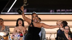 actress sheryl lee ralph hoisting her emmy award in the air