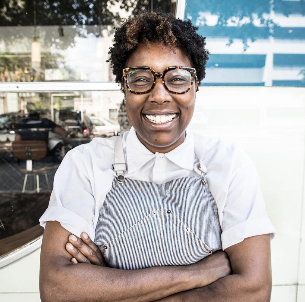 Mashama Bailey, Black female chef smiling with an apron on