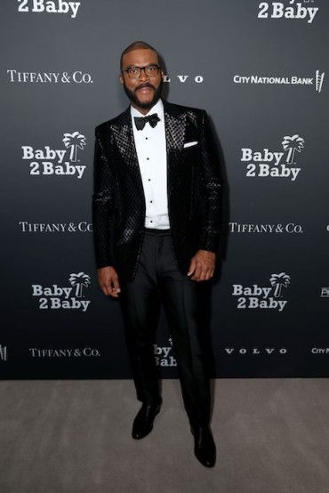 Tyler Perry looks sleek in a Tom Ford embossed black blazer and black trousers. Image: Phillip Faraone for Getty Images for Baby2Baby