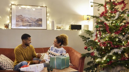 Cheerful Couple Enjoying Christmas At Home