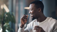 Man taking supplements from Black-owned vitamin brands