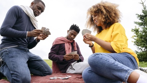 Family playing black-owned card games