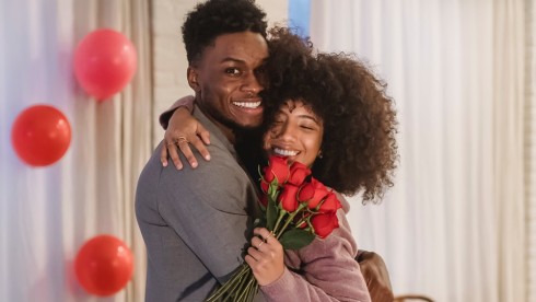 black couple with red roses and flowers