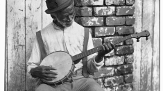 man playing banjo archival